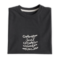 Folded black sweatshirt with white Arabic text on a light gray background
