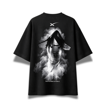 A black short-sleeve t-shirt with a large black-and-white graphic of a space shuttle emerging from smoke on the front. The shirt features a white stylized 'X' logo on the upper chest and the text 'THE FUTURE IS PUBLIC' near the bottom of the graphic, displayed against a clean white background.