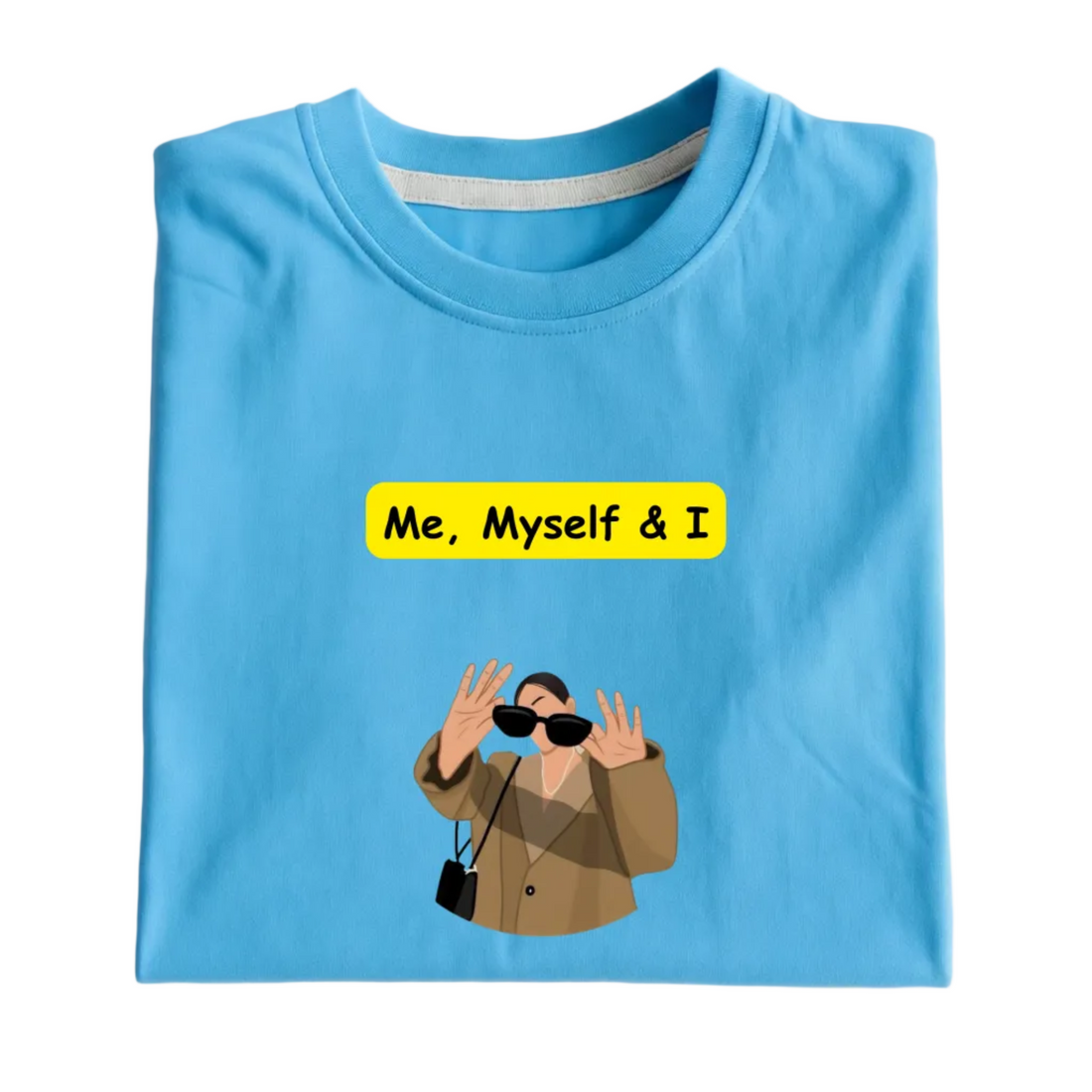Folded blue t-shirt with 'Me, Myself & I' text and graphic on a white background