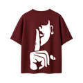 Maroon oversized graphic T-shirt featuring a large abstract face illustration on the back.