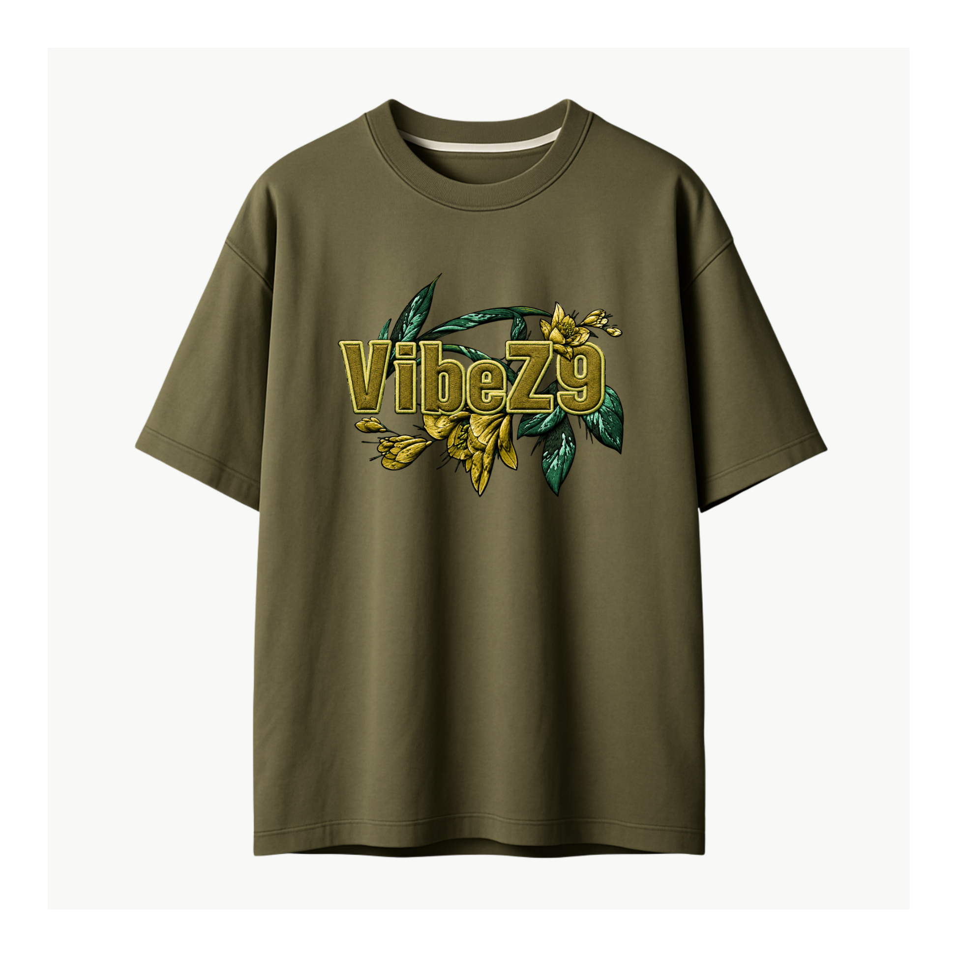 An olive green short-sleeve t-shirt with a graphic on the chest featuring the text 'VibeZ9' in gold with a 3D effect, overlaid with yellow flowers and green leaves, shown against a plain off-white background.