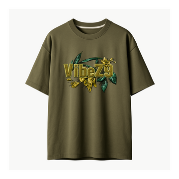 An olive green short-sleeve t-shirt with a graphic on the chest featuring the text 'VibeZ9' in gold with a 3D effect, overlaid with yellow flowers and green leaves, shown against a plain off-white background.