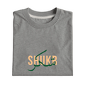 Folded gray t-shirt with 'SHUKR' text in green and orange on a light gray background