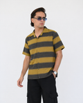 Man wearing a striped shirt and sunglasses against a white background
