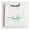A folded white crewneck t-shirt with a green heartbeat line graphic and the word 'ZINDABAD' printed in black below it, displayed on a light off-white background.