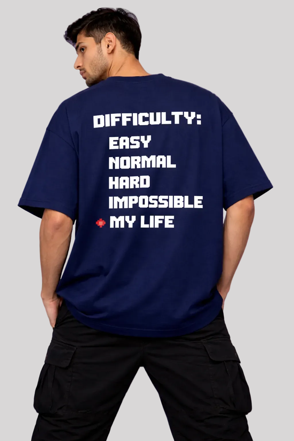 Person wearing a navy blue t-shirt with a graphic design on a light purple background
