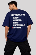 Person wearing a navy blue t-shirt with motivational text on the back against a light purple background