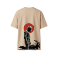 A beige short-sleeve t-shirt shown from the back, featuring a graphic print of a motorcycle rider in black and gray standing in front of a red circle.