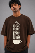 Man wearing a brown t-shirt with a coffee-themed design on a gray background