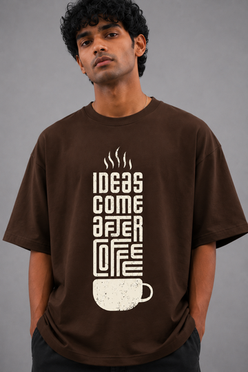 Man wearing a brown t-shirt with a coffee-themed design on a gray background