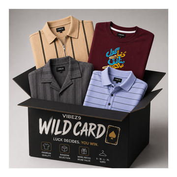 A black VIBEZ9 'Wild Card' mystery box filled with folded clothing, including a beige striped polo, a maroon graphic T-shirt, a dark gray collared shirt, and a light blue striped polo, on a neutral gray background.